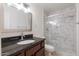Bathroom boasts a walk-in shower and dark vanity at 10801 N 45Th St, Phoenix, AZ 85028