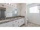 Bathroom boasts double sinks, granite countertop, and updated vanity at 10801 N 45Th St, Phoenix, AZ 85028