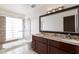 Bathroom with granite vanity, large mirror, and shower/tub combo at 10801 N 45Th St, Phoenix, AZ 85028