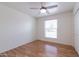 Well-lit bedroom featuring wood floors, a window, and ceiling fan at 10801 N 45Th St, Phoenix, AZ 85028