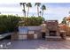 Backyard oasis with an outdoor kitchen and fireplace at 10801 N 45Th St, Phoenix, AZ 85028