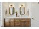 Bathroom with double vanity, mirrors, and grey hexagon tile floors at 11549 E Bella Vista Dr, Scottsdale, AZ 85259