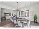 Bright dining room with a large table, modern chandelier, and hardwood floors at 12659 E Shadow Ridge Dr, Scottsdale, AZ 85255