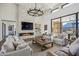 Open living area with a stone fireplace and access to the backyard at 12659 E Shadow Ridge Dr, Scottsdale, AZ 85255