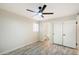 Bright bedroom with ceiling fan and double doors to closet at 1331 W Baseline Rd # 122, Mesa, AZ 85202