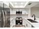 Modern kitchen with stainless steel appliances and white shaker cabinets at 1331 W Baseline Rd # 122, Mesa, AZ 85202