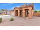 Two-story house with tan exterior, two-car garage, and landscaping at 1343 E Walnut Rd, Gilbert, AZ 85298