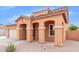 Two-story house with tan exterior, two-car garage, and landscaping at 1343 E Walnut Rd, Gilbert, AZ 85298