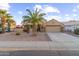 Tan house with palm trees, a two-car garage, and a well-maintained front yard at 14639 W Via Manana Dr, Sun City West, AZ 85375