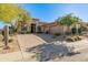 Single-story home with desert landscaping, two-car garage, and a large driveway at 15637 E Cactus Dr, Fountain Hills, AZ 85268