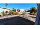 Landscaped backyard with wrought-iron fence and desert plants at 2400 E Baseline Ave # 144, Apache Junction, AZ 85119