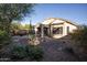Spacious backyard with covered patio, fire pit, and desert landscaping at 26053 W Tonopah Dr, Buckeye, AZ 85396