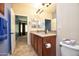 Bathroom with double sinks, a large mirror, and a shower at 26053 W Tonopah Dr, Buckeye, AZ 85396