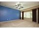 Bright bedroom with bay window and ceiling fan at 26053 W Tonopah Dr, Buckeye, AZ 85396