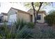 Front view of a charming one-story home with desert landscaping at 26053 W Tonopah Dr, Buckeye, AZ 85396