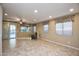Large living room with tile floor and ceiling fan at 26053 W Tonopah Dr, Buckeye, AZ 85396