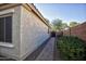 Side yard with brick walkway leading to a gate at 26053 W Tonopah Dr, Buckeye, AZ 85396