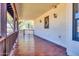 Long covered porch with tile flooring and wooden railings at 31218 N 49Th St, Cave Creek, AZ 85331