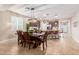 Bright dining room features a large table and modern lighting at 31625 N 132Nd Dr, Peoria, AZ 85383