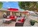 Relaxing patio with seating area, red umbrellas, and adjacent pool at 6252 E Pearl St, Mesa, AZ 85215