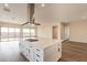 Modern kitchen with white cabinets, quartz countertops, and a large island at 797 E Las Puertas Ln, Queen Creek, AZ 85140