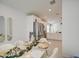 Elegant dining area with white chairs and a decorative table next to the kitchen at 9612 W Trumbull Rd, Tolleson, AZ 85353