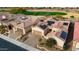 Aerial view showing a community of houses with solar panels and a golf course at 26822 W Oraibi Dr, Buckeye, AZ 85396