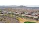 Aerial view of community, showcasing numerous houses and a golf course at 26822 W Oraibi Dr, Buckeye, AZ 85396