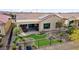 Single-story home with backyard patio and putting green at 26822 W Oraibi Dr, Buckeye, AZ 85396