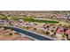 Aerial view of neighborhood with golf course and solar panels at 26822 W Oraibi Dr, Buckeye, AZ 85396