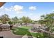 Landscaped backyard with artificial turf and a golf course view at 26822 W Oraibi Dr, Buckeye, AZ 85396