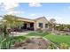 Artificial turf, desert landscaping, and a covered patio at 26822 W Oraibi Dr, Buckeye, AZ 85396