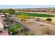Elevated view of backyard, featuring a putting green, and a golf course beyond at 26822 W Oraibi Dr, Buckeye, AZ 85396