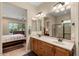 Double vanity bathroom with view into bedroom and shower at 26822 W Oraibi Dr, Buckeye, AZ 85396