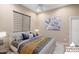 Virtually staged bedroom with comfortable bed and ceiling fan at 26822 W Oraibi Dr, Buckeye, AZ 85396