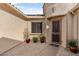 Courtyard entry with brick pavers, potted plants, and a security door at 26822 W Oraibi Dr, Buckeye, AZ 85396