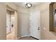 Bright entryway with white door, neutral walls, and tiled flooring at 26822 W Oraibi Dr, Buckeye, AZ 85396