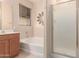 Bathroom with bathtub, shower, and wood cabinets at 298 E Diamond Trl, San Tan Valley, AZ 85143