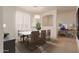 Bright dining room with a white table, modern chairs, and large windows at 298 E Diamond Trl, San Tan Valley, AZ 85143