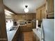 Full kitchen view, yellow appliances and wood cabinets at 4065 E University Dr # 140, Mesa, AZ 85205