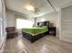 Bedroom with a queen bed, chair, and built-in shelving at 5201 W Camelback W Rd # D69, Phoenix, AZ 85031