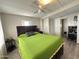 Bright bedroom featuring a lime green bedspread and built-in closet at 5201 W Camelback W Rd # D69, Phoenix, AZ 85031