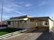 Tan mobile home with carport and artificial turf at 5201 W Camelback W Rd # D69, Phoenix, AZ 85031