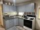Modern kitchen with gray cabinets, an island, and stainless steel appliances at 5201 W Camelback W Rd # D69, Phoenix, AZ 85031