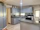 Modern kitchen with gray cabinets, an island, and stainless steel appliances at 5201 W Camelback W Rd # D69, Phoenix, AZ 85031