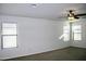 Spacious bedroom with two windows and ceiling fan at 9527 N 82Nd Ln, Peoria, AZ 85345