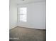Bright bedroom with carpeted floor and large window at 9527 N 82Nd Ln, Peoria, AZ 85345