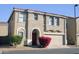 Tan two-story house with a red door and attached two-car garage at 9527 N 82Nd Ln, Peoria, AZ 85345