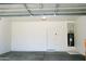 Garage with automatic door, water heater, and storage at 9527 N 82Nd Ln, Peoria, AZ 85345