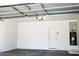 Garage with automatic door, water heater, and storage at 9527 N 82Nd Ln, Peoria, AZ 85345
